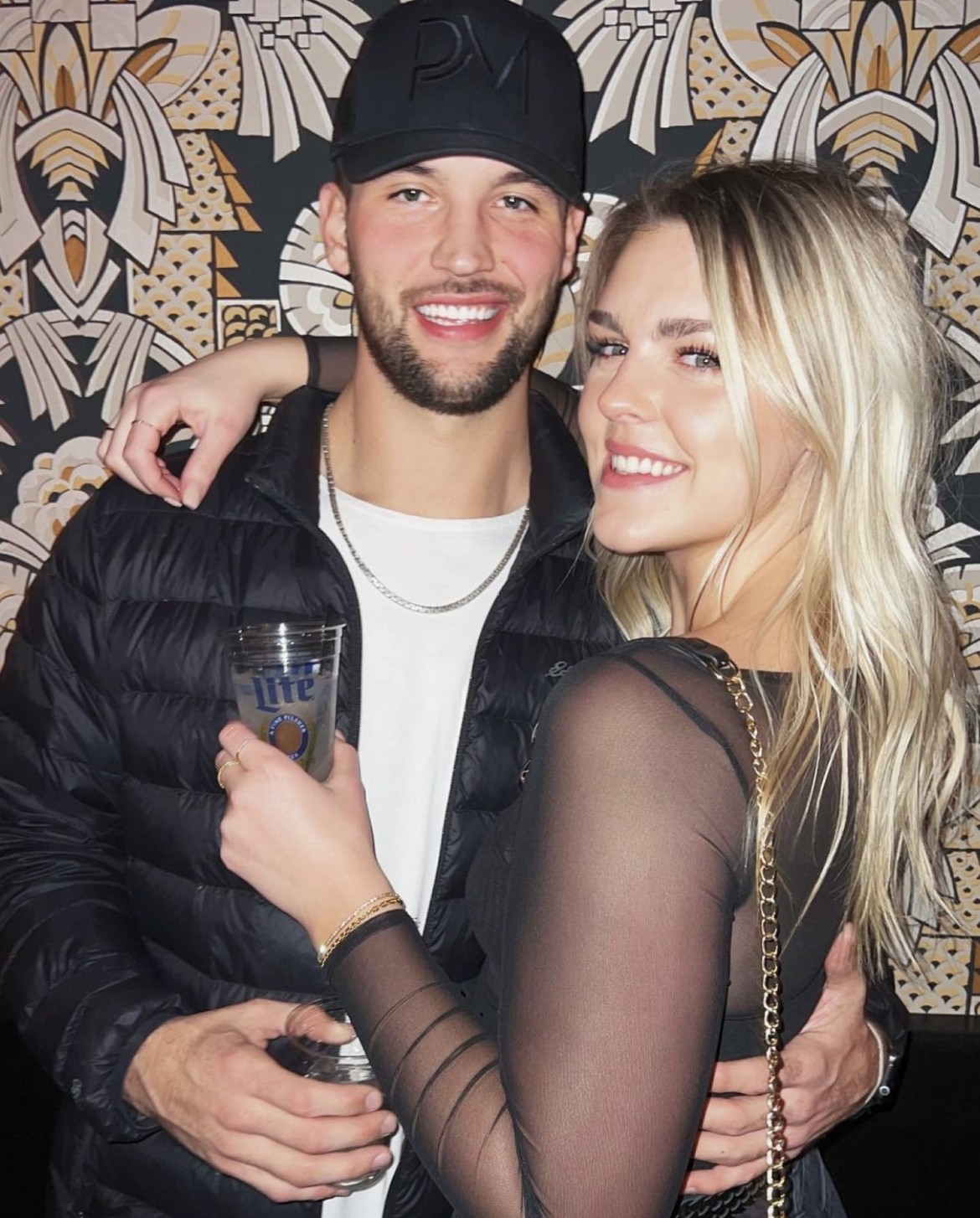 Alex Dubord and Natalie pose for a picture wearing our LE 1ED hat