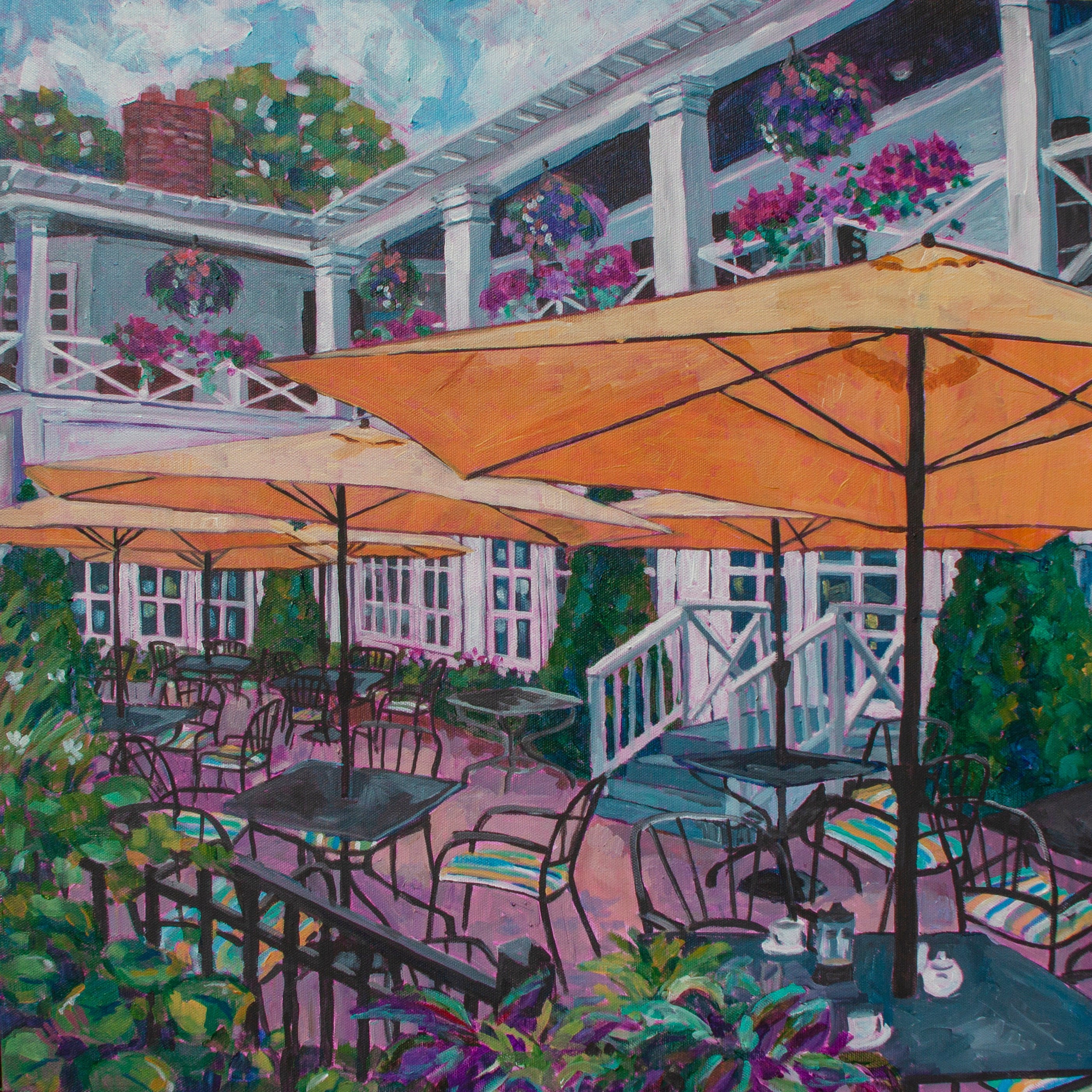 Cafe patio with tables, chairs, yellow umbrellas and flowers from Niagara on the Lake, Ontario Canada