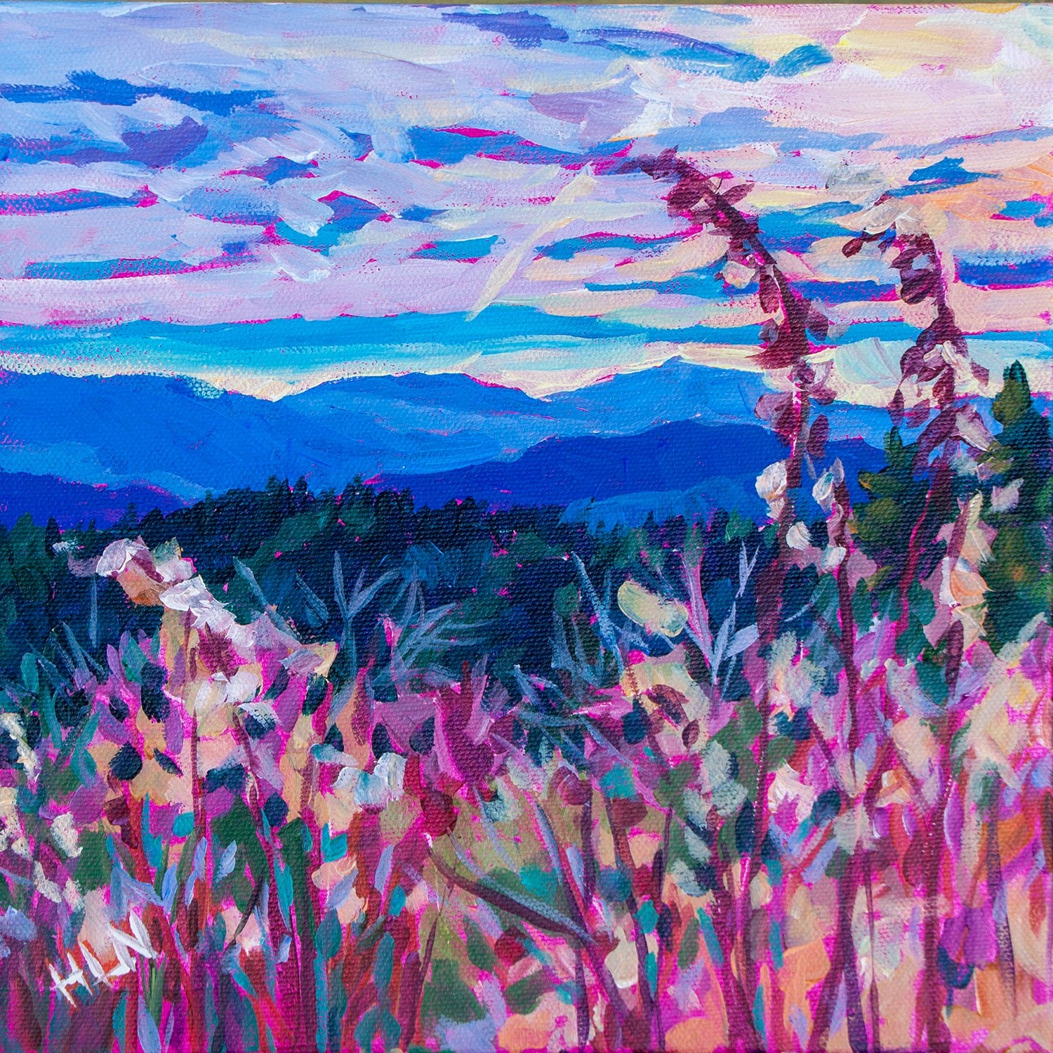 Blue smoky mountains with grass and flowers in the foreground