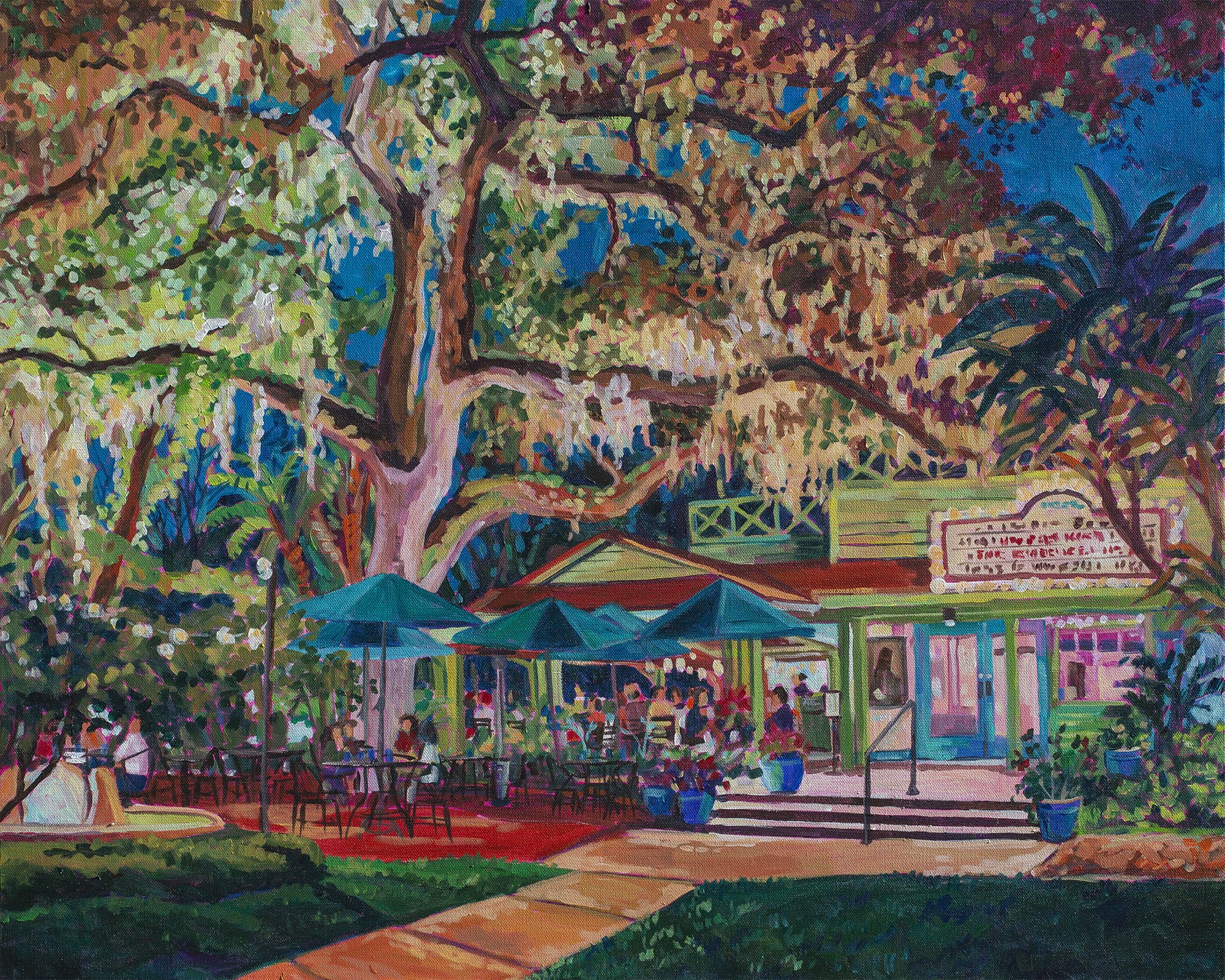 Night scene of outdoor bar/cafe with umbrellas, giant oak tree and tables of Enzian Theatre in Maitland/Winter Park Florida