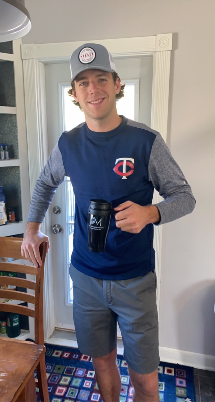 Derek Herzog wearing our 3rd Edition Patch hat and using our PM mug