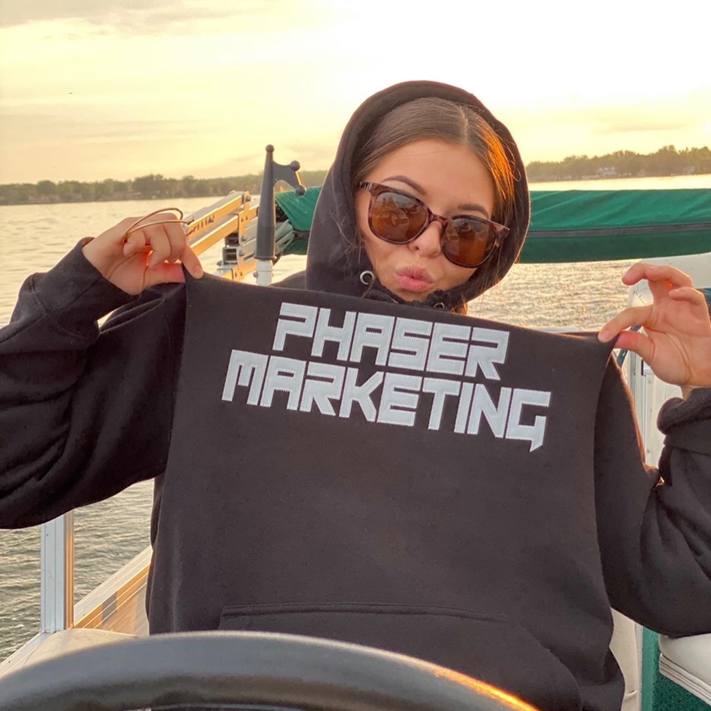 Lily wearing our black Phaser sweatshirt on the boat